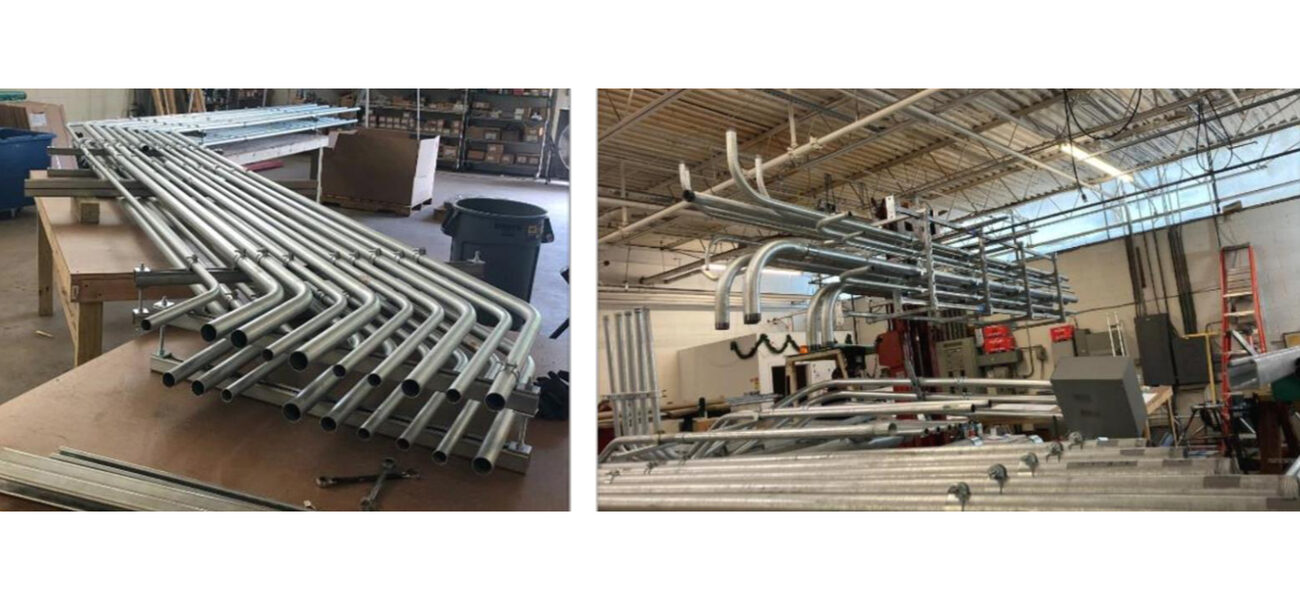 piping systems lie on the floor and hang in ceiling racks of a large warehouse