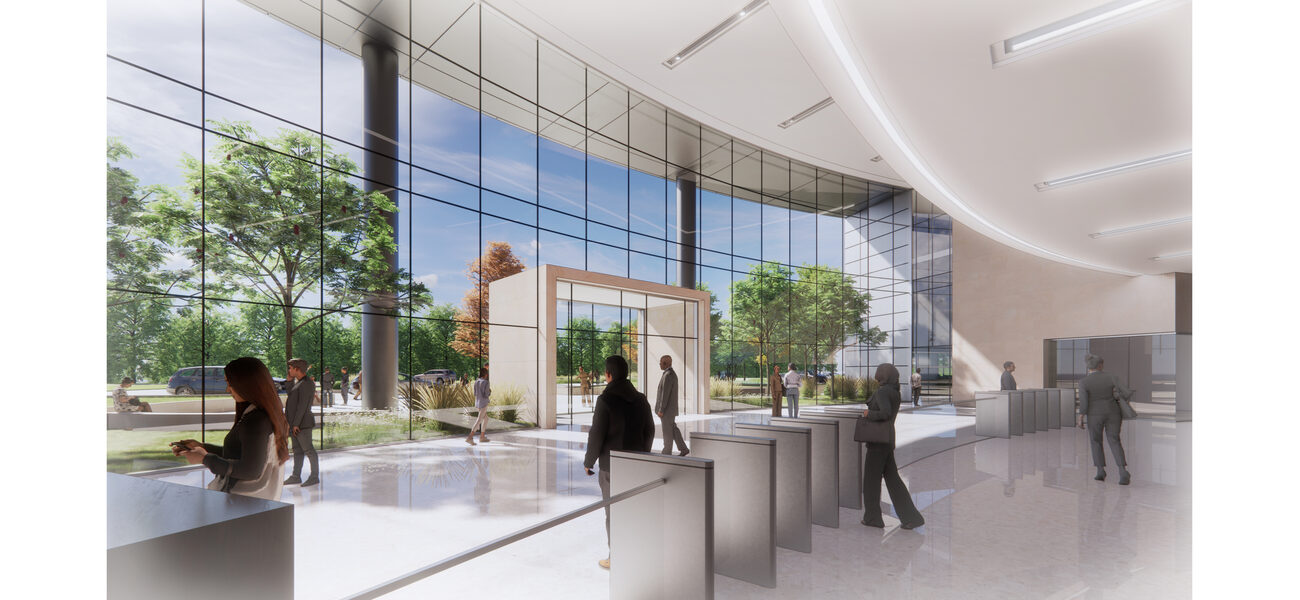 People walk in front of a large wall of floor-to-ceiling windows