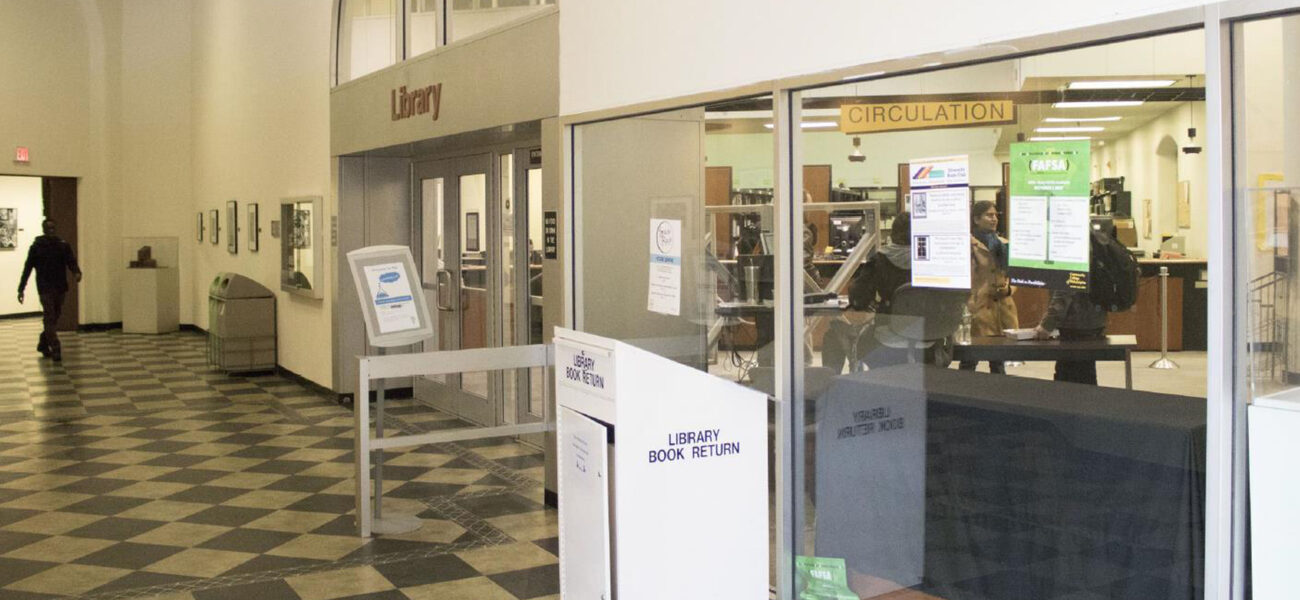 A glass wall and a locked door secure the entrance to the library